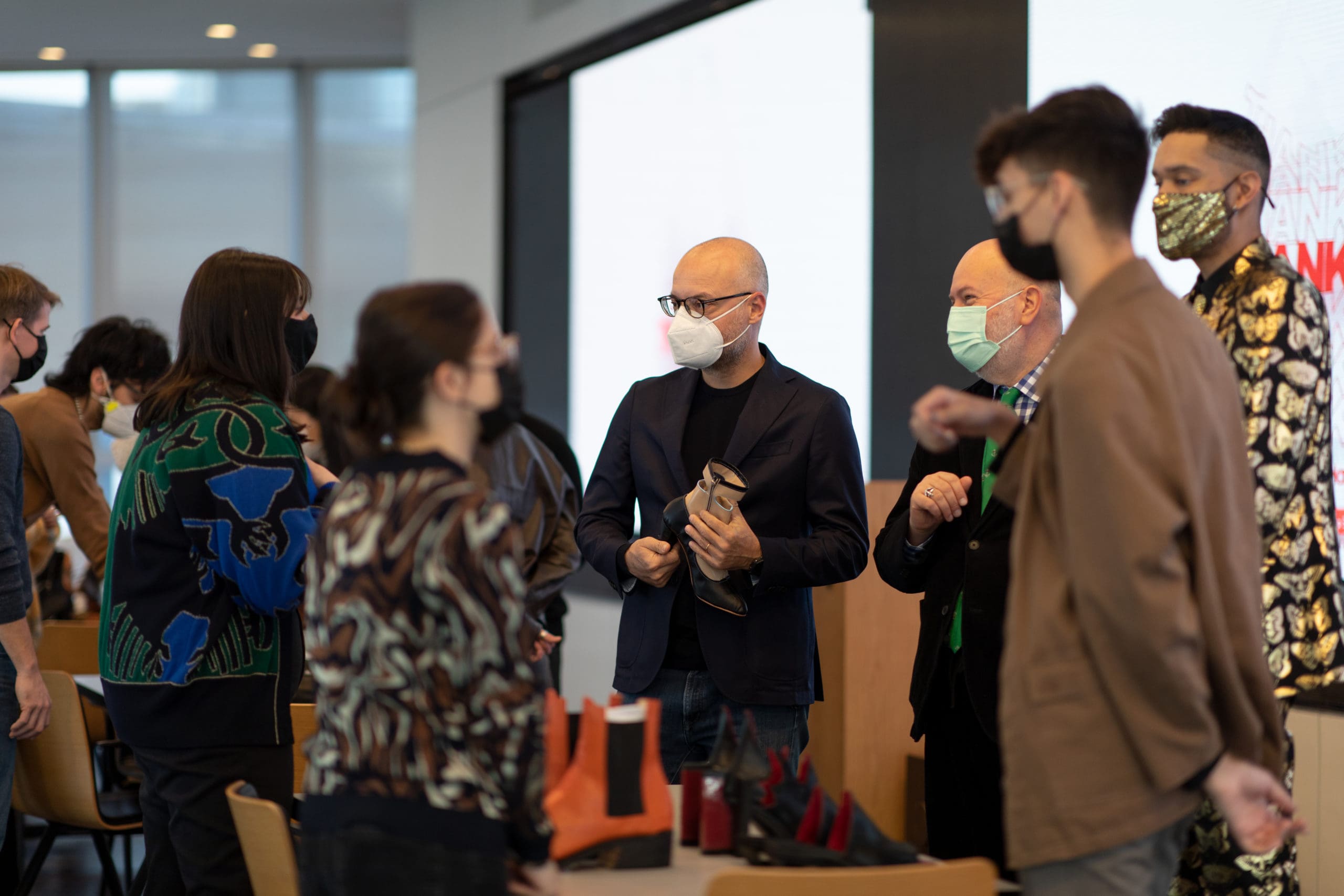 Students discuss their designs with Stuart Weitzman CEO and Aki Choklat