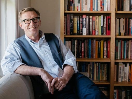 Portrait Shot of CCS President Don Tuski on a couch in front of a bookshelf, next to a sunny window